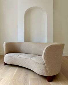 a couch sitting on top of a hard wood floor