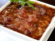 a white plate topped with beans and meat