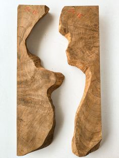 two pieces of wood that have been cut into shapes