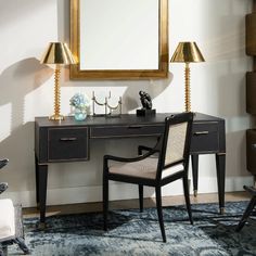 a desk with a chair, mirror and lamp on it