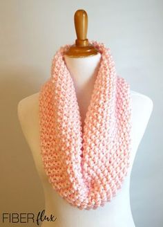 a pink knitted scarf on top of a mannequin