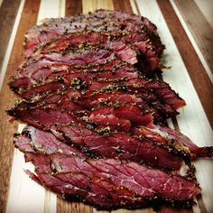 sliced steak on a cutting board with seasoning sprinkles