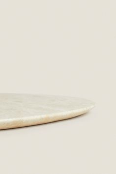 a white marble surfboard sitting on top of a table