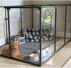 a dog is sitting in its kennel with his food and water bowl on the floor