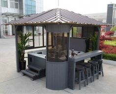 an outdoor hot tub with stools next to it