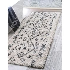 a white rug with black and grey designs on it