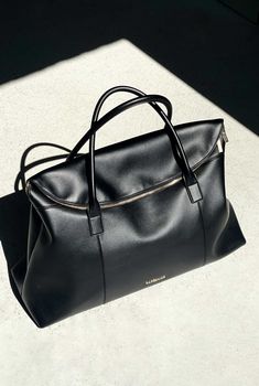 The Hugo Duffle by Nakedvice is a unisex duffle bag crafted from smooth black leather and gold hardware. Featuring two top handles, The Hugo Duffle opens up to a spacious interior with plenty of room to store your travel essentials. We designed The Hugo Duffle so that it can be used as an overnight bag, gym bag, baby bag, or travel bag.
 Colour: BLACK/GOLD Luxury Baguette Pouch Bag For Daily Use, Luxury Formal Nylon Bags, Timeless Black Luxury Evening Bag, Chic Black Weekender Bag With Luggage Sleeve, Large Duffle Bag, Chic Black Travel Bag With Zipper, Chic Black Travel Bag With Zipper Closure, Chic Black Travel Bag For Business, Chic Black Weekender Bag With Top Carry Handle