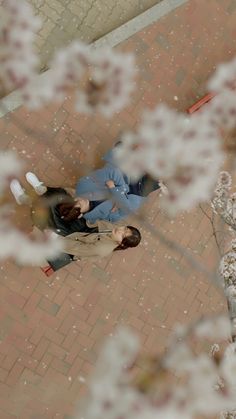 two people walking down a sidewalk in the snow