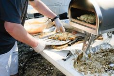 a man grilling food on an outdoor grill