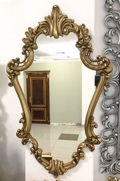 a mirror that is on the wall in front of a door and some other mirrors