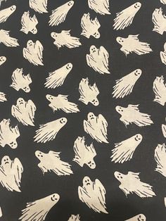 a black and white pattern with ghost faces on it