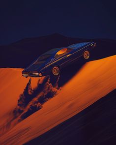 a blue car driving on top of a sand dune in the desert at night time