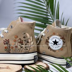 a pair of shoes with flowers painted on them