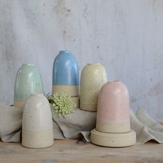 five ceramic salt and pepper shakers sitting next to each other on a wooden table