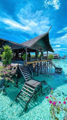 the water is crystal blue and clear with some chairs on it in front of a dock