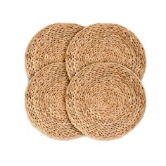 four round placemats made out of straw