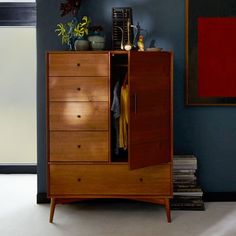 a wooden cabinet sitting in front of a blue wall