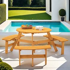 a wooden picnic table sitting next to a swimming pool