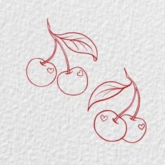 two cherries with leaves and hearts drawn on paper