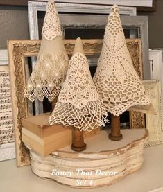 three small crocheted christmas trees sitting on top of a table