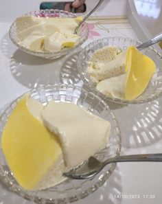 three plates with slices of cake on them and a spoon in the bowl next to it