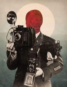 a man holding an old camera in front of a red ball on top of his head