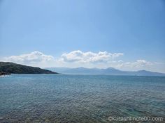 the water is crystal blue and clear with mountains in the distance