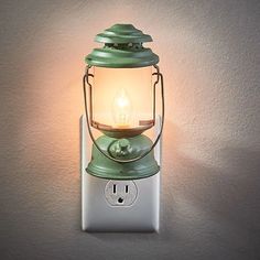 a light that is on the side of a wall next to a plug in an outlet