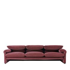 a red couch sitting on top of a white floor