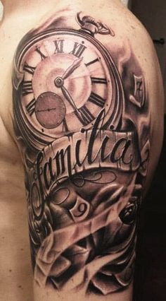 a man's arm with a clock and lettering on it, in black and grey