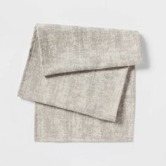 two linen napkins on top of each other, one in grey and the other in white