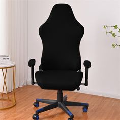 a black office chair sitting on top of a hard wood floor