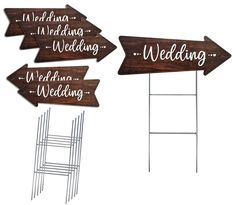 three wooden signs with the words wedding, we're married and two ladders