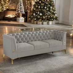 a white couch sitting in front of a christmas tree