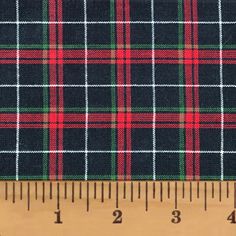 a ruler is next to a plaid fabric