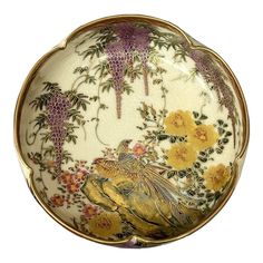 a decorative plate with flowers and birds on it