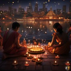 two women sitting on the ground in front of a lake with lit candles around them