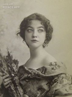 an old black and white photo of a woman with flowers in her hands, wearing a dress