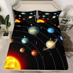 an image of a bed with solar system on the cover and pillow cases in it