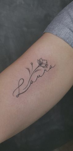 a woman's arm with the word love written in cursive writing