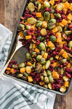 a pan filled with brussel sprouts, brussels sprouts and cranberries