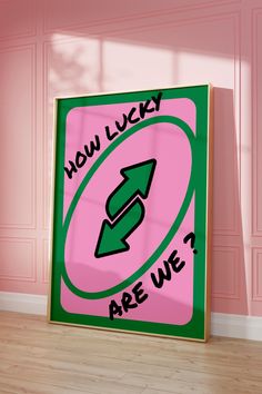 a pink and green sign that says how lucky are we? with an arrow pointing to the right