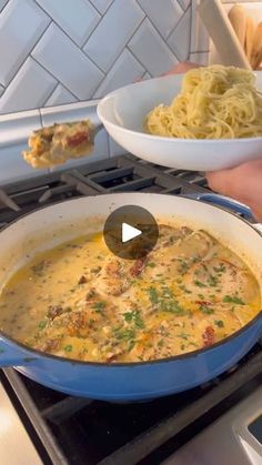 someone is holding a spoon over a bowl of food on top of an oven burner