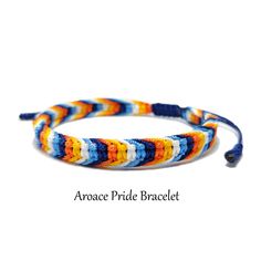 an orange, blue and white bracelet with beads on it's end is shown