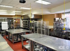 an industrial kitchen with stainless steel counters and appliances