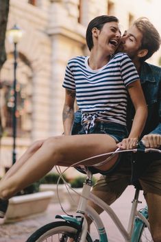 a man riding on the back of a bike next to a woman