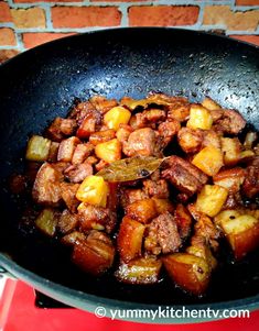 some food is cooking in a skillet on the stove top and ready to be eaten