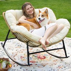 a woman sitting in a rocking chair with her dog