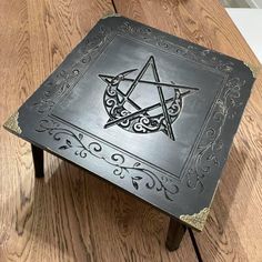 a metal table with a pentagramus design on it