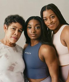 three women posing for the camera with their arms around each other